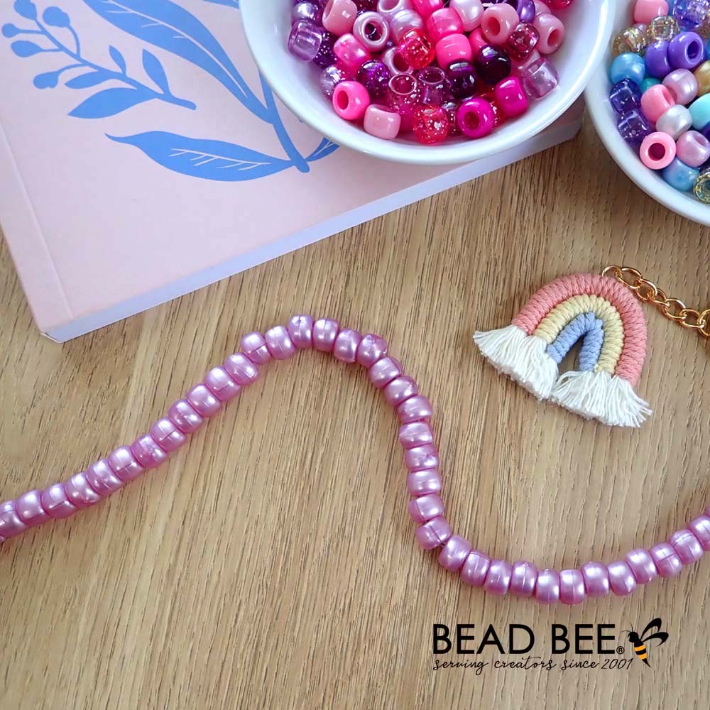 mauve pearl pony beads displayed with other beads and crafts supplies on table