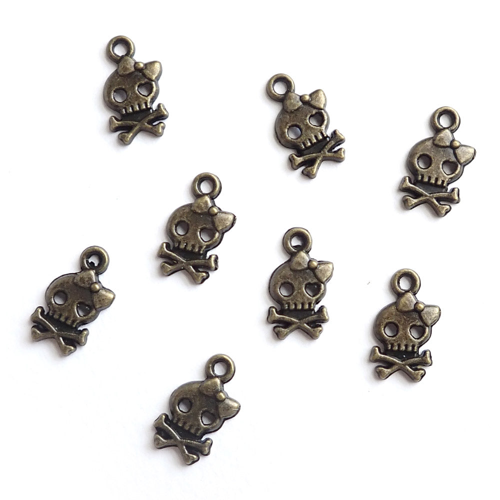 Skull &amp; Cross bones w/ Bow, Antique Bronze Color, about 8 charms