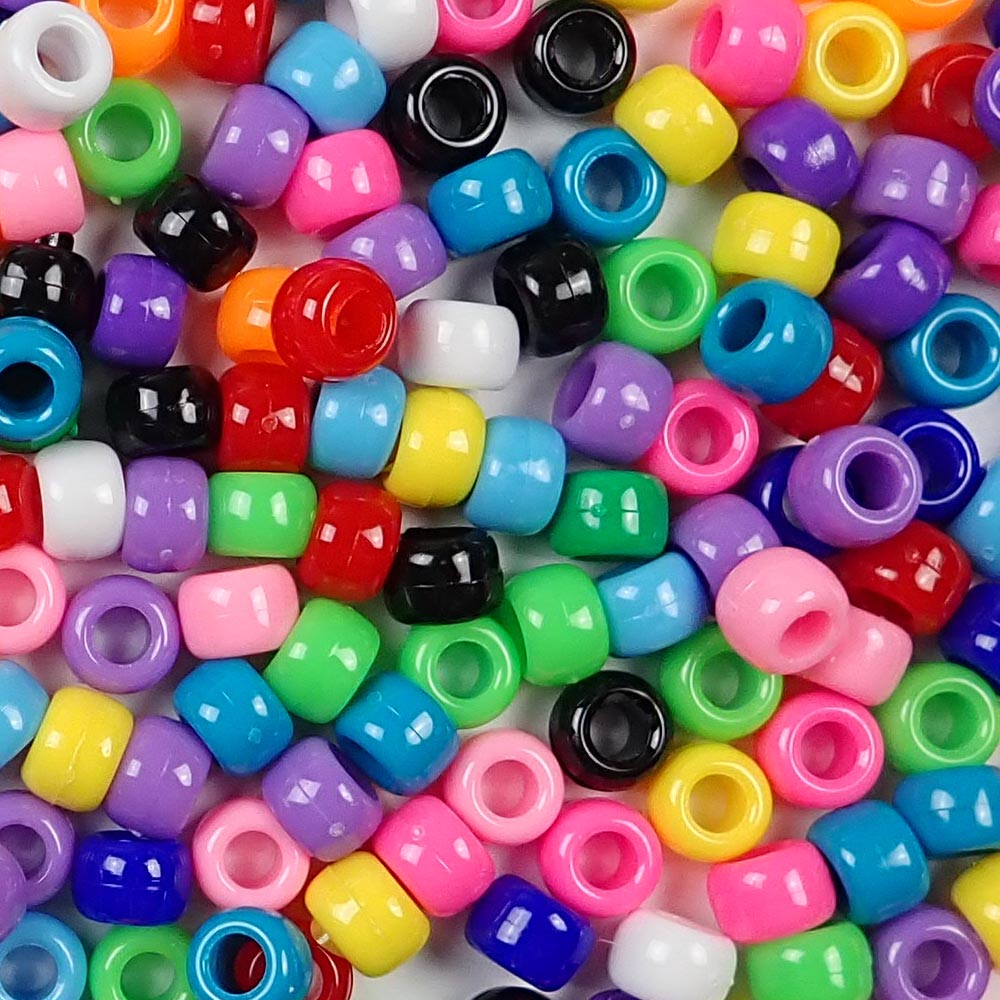 An assortment of opaque colors of 6 x 9mm Plastic Pony Beads